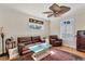 Comfortable living room features a leather sofa, unique glass table, and lots of natural light at 6405 Gulf Dr, Holmes Beach, FL 34217