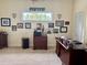 Office space features a large desk, soft carpet, and numerous wall decorations at 6405 Gulf Dr, Holmes Beach, FL 34217