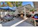 Outdoor kitchen with grill, dining table, and covered seating area for relaxing and entertaining at 6405 Gulf Dr, Holmes Beach, FL 34217