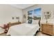 Bright bedroom with wicker furniture and window seating at 658 Barnacle Ct, Englewood, FL 34223