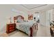 Main bedroom with a king-size bed, wooden furniture, and access to a private space at 658 Barnacle Ct, Englewood, FL 34223