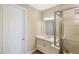 Bright bathroom featuring a white vanity, framed mirror, shower with tile surround and glass enclosure at 660 Ravello Blvd, Nokomis, FL 34275