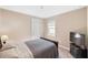 Cozy bedroom with neutral walls, comfortable bed, and a television on a dresser at 660 Ravello Blvd, Nokomis, FL 34275