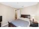 Bedroom with neutral walls and carpet and a dark-stained queen bed at 660 Ravello Blvd, Nokomis, FL 34275