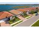 Beautiful single-Gathering homes showcasing tile roofs, brick driveways, lush landscaping, and serene waterfront views at 660 Ravello Blvd, Nokomis, FL 34275