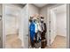 Hallway featuring open doorways and a shelf with clothes, baskets and boxes at 660 Ravello Blvd, Nokomis, FL 34275
