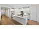 Bright kitchen features white cabinetry, stainless steel appliances, and a spacious center island at 660 Ravello Blvd, Nokomis, FL 34275