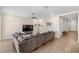 Spacious living room with hardwood floors and a modern ceiling fan, perfect for relaxing and entertaining at 660 Ravello Blvd, Nokomis, FL 34275