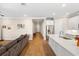 Spacious living area with wood floors adjacent to the kitchen with stainless steel appliances at 660 Ravello Blvd, Nokomis, FL 34275