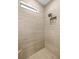 Modern shower featuring a tile surround, glass enclosure and a corner bench at 660 Ravello Blvd, Nokomis, FL 34275