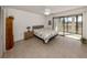 Bedroom with a queen bed and sliding glass doors to a balcony at 694 Bird Bay W Dr # 137, Venice, FL 34285