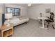 Bright bedroom with a queen bed, desk, and tiled floors at 694 Bird Bay W Dr # 137, Venice, FL 34285
