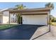 Covered carport with a storage unit and ample parking space at 694 Bird Bay W Dr # 137, Venice, FL 34285