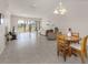 Combined living and dining area with tile flooring and a wooden table at 694 Bird Bay W Dr # 137, Venice, FL 34285