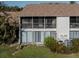 Rear exterior view of condo with screened balcony and AC units at 694 Bird Bay W Dr # 137, Venice, FL 34285