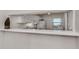 Kitchen features white cabinets, granite countertops, and a breakfast bar at 694 Bird Bay W Dr # 137, Venice, FL 34285