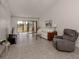 Bright living room with tile floors, and access to a patio at 694 Bird Bay W Dr # 137, Venice, FL 34285