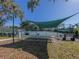 Relaxing shaded tennis court with benches at 694 Bird Bay W Dr # 137, Venice, FL 34285