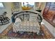 Cozy bedroom with a metal bed frame, colorful rug, and decorative pillows at 722 Caribbean Cir # 10, Venice, FL 34293