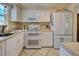 White kitchen with double oven, microwave, and ample counter space at 722 Caribbean Cir # 10, Venice, FL 34293