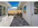 Charming patio with gray pavers, metal table and chairs, and umbrella at 722 Caribbean Cir # 10, Venice, FL 34293