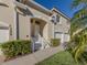 Front view of condo with double doors, two-car garage, and manicured hedges at 7236 Cedar Hollow Cir # 11-202, Bradenton, FL 34203