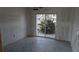 Bright living room area featuring tile floors and sliding glass door to outside patio at 902 Gibbs Rd # 183, Venice, FL 34285