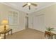 Bright bedroom with ceiling fan, double closets and window at 9028 Coachman Dr, Venice, FL 34293