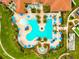 Community pool and recreation area with multiple lounge chairs and umbrellas at 10185 Colubrina Dr, Venice, FL 34293