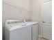 Bright laundry room with washer, dryer, and ample shelving at 10185 Colubrina Dr, Venice, FL 34293