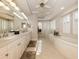 Elegant bathroom with double vanity, soaking tub, and glass block shower at 110 Martellago Dr, North Venice, FL 34275