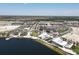 Scenic aerial view of Wellen Park, featuring a lake and various buildings at 12280 Wellen Golf St # 104, Venice, FL 34293