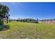 Spacious backyard with green grass and a partial view of the house at 12329 Veronese St, North Port, FL 34287