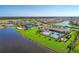 Aerial view of community with lake, homes, and recreational amenities at 13812 Alafaya St, Venice, FL 34293