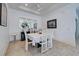 Modern dining area with white table and chairs, and decorative accents at 143 Fontanelle Cir, Venice, FL 34292