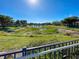 Scenic pond view with green grass and homes in the background at 143 Fontanelle Cir, Venice, FL 34292