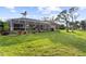 Spacious backyard with pool and lush green lawn at 150 Marker Rd, Rotonda West, FL 33947