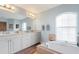 Spa-like bathroom with double vanity, soaking tub, and large mirror at 150 Marker Rd, Rotonda West, FL 33947