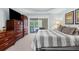 Spacious Primary bedroom with king-size bed and access to the pool at 150 Marker Rd, Rotonda West, FL 33947
