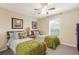 Guest bedroom with twin beds, green bedding, and large window at 150 Marker Rd, Rotonda West, FL 33947
