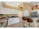 Bright kitchen features white cabinets, granite countertops, and a breakfast bar at 150 Marker Rd, Rotonda West, FL 33947