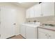 Convenient laundry room with washer, dryer, and storage cabinets at 150 Marker Rd, Rotonda West, FL 33947