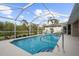 Relaxing screened-in pool with lush landscaping at 150 Marker Rd, Rotonda West, FL 33947