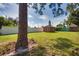 Spacious backyard with shed and tall tree at 1605 Phillip Pl, Englewood, FL 34223