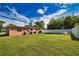 Large backyard with grassy area, patio, and privacy fence at 1605 Phillip Pl, Englewood, FL 34223