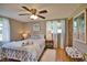 Cozy bedroom with ceiling fan, anchor bedding, and ample natural light at 1605 Phillip Pl, Englewood, FL 34223