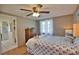 Spacious bedroom with ceiling fan, dresser, and en-suite bathroom access at 1605 Phillip Pl, Englewood, FL 34223