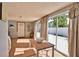 Small dining area with table and chairs, adjacent to sliding glass doors at 1605 Phillip Pl, Englewood, FL 34223