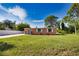 Cute ranch home with fenced yard, mature trees, and a peach exterior at 1605 Phillip Pl, Englewood, FL 34223