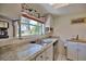 Well-lit kitchen with granite countertops and updated appliances at 1605 Phillip Pl, Englewood, FL 34223